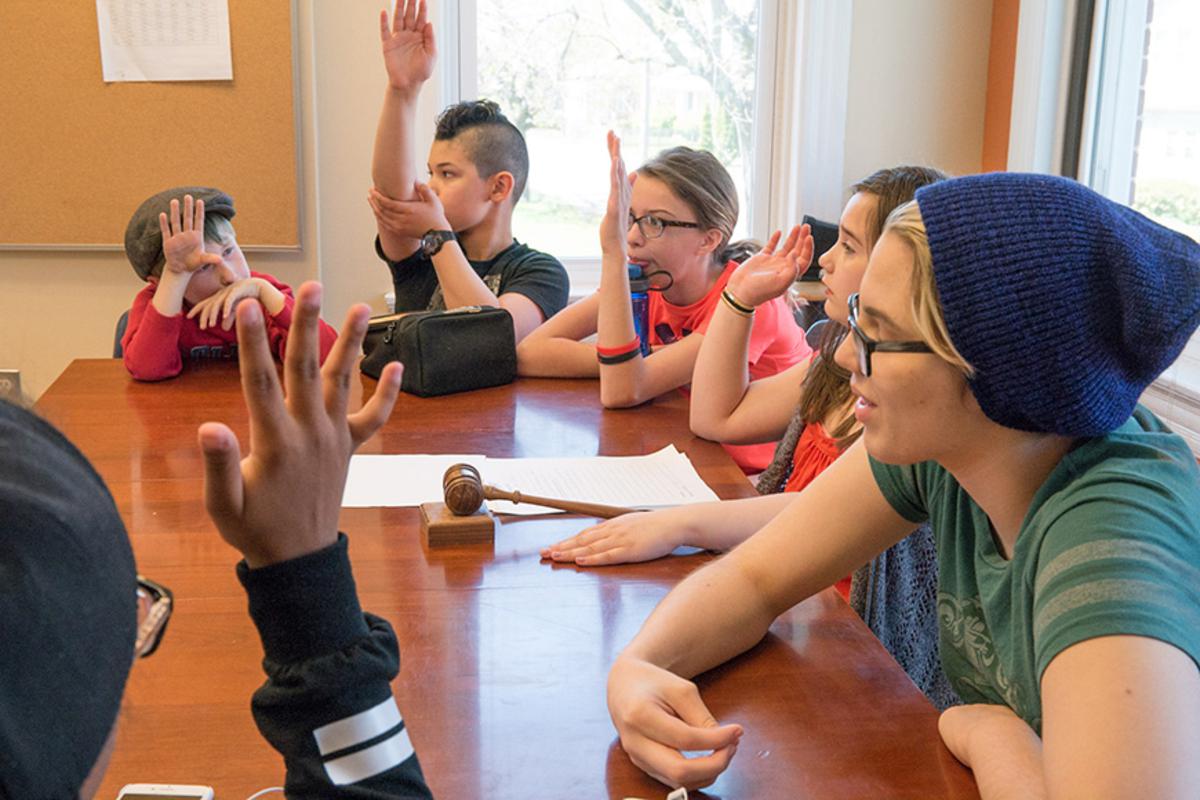 Several students in a committee meeting